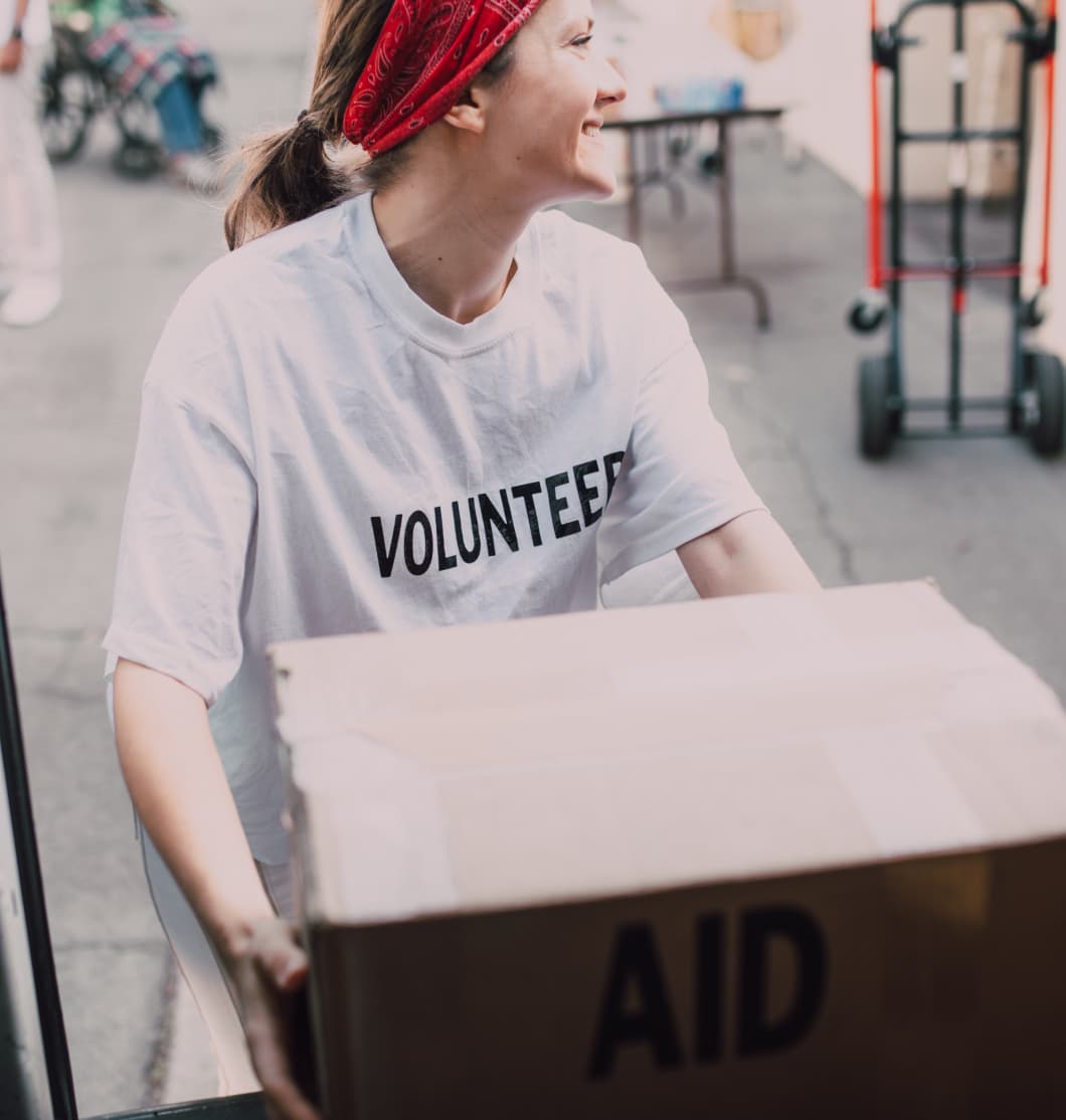 volunteer holding a box of donations